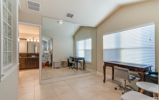 office area with lofted ceiling and light tile patterned floors