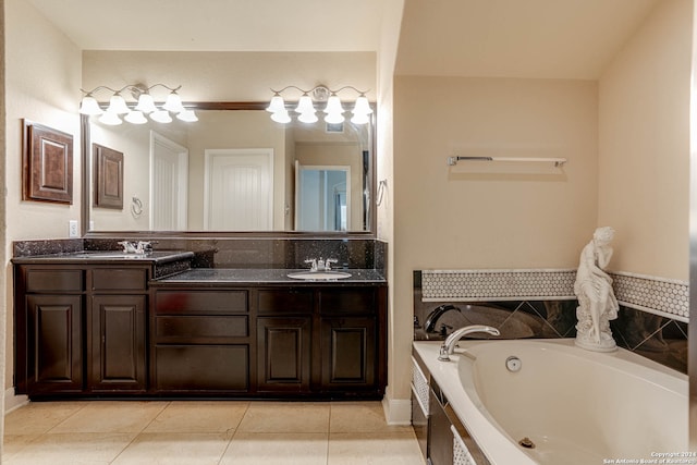 bathroom with vanity, tile patterned flooring, and a washtub