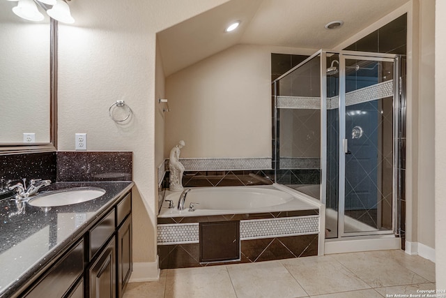 bathroom with tile patterned floors, independent shower and bath, and vanity