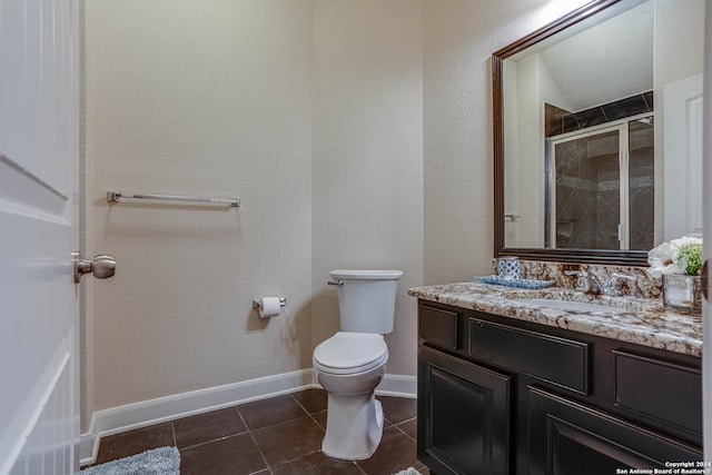 bathroom with walk in shower, vanity, toilet, and tile patterned floors