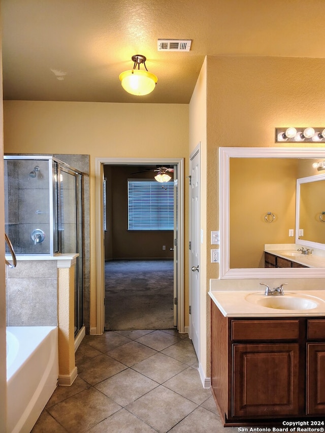 bathroom featuring vanity, tile patterned floors, and separate shower and tub