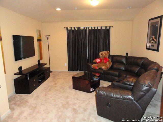 empty room with carpet flooring and lofted ceiling