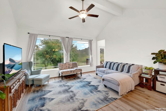 living area with wood finished floors, beamed ceiling, a ceiling fan, and high vaulted ceiling