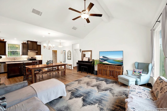 living room featuring light wood-style floors, ceiling fan with notable chandelier, visible vents, and beam ceiling