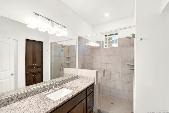 bathroom with vanity and a shower stall