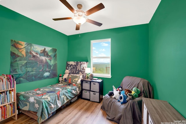 bedroom featuring wood finished floors and ceiling fan