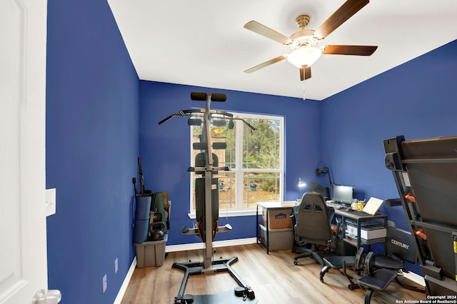 home office with baseboards, ceiling fan, and wood finished floors