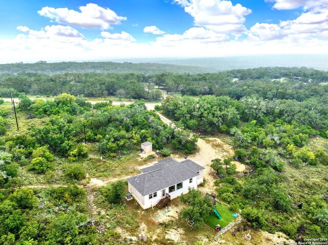 aerial view featuring a wooded view