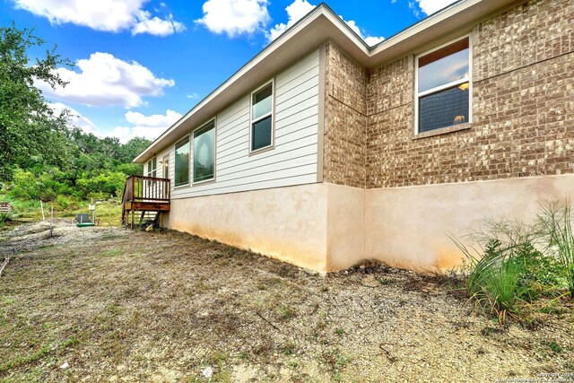 view of property exterior featuring a wooden deck