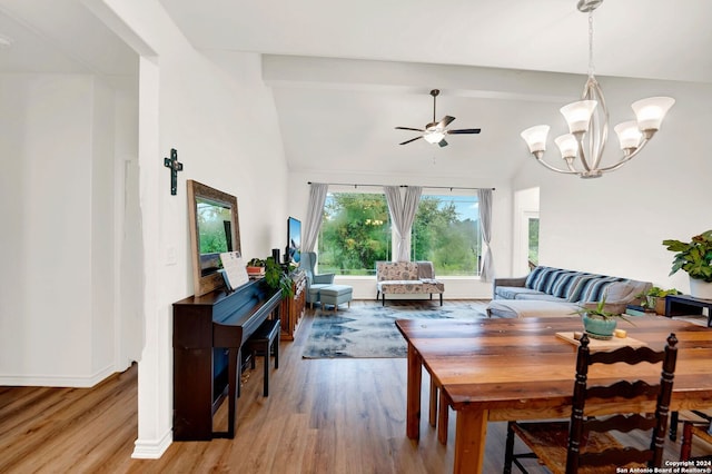 dining area with ceiling fan with notable chandelier, baseboards, lofted ceiling with beams, and light wood-style floors