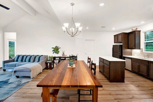 dining space with recessed lighting, light wood-type flooring, an inviting chandelier, and vaulted ceiling with beams