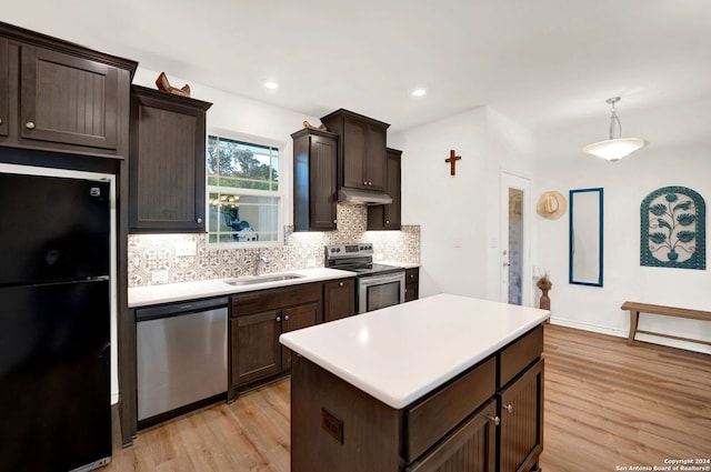 kitchen featuring appliances with stainless steel finishes, light hardwood / wood-style floors, sink, a kitchen island, and dark brown cabinetry