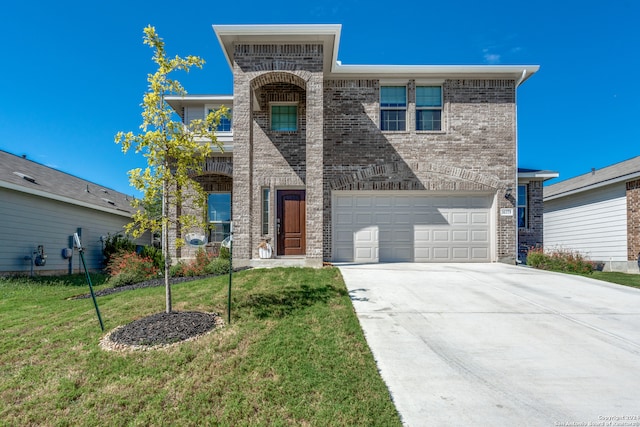 view of front of home with a garage and a front lawn