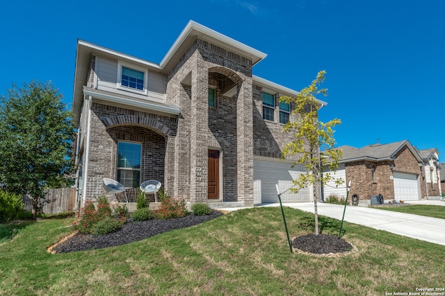 view of front of home featuring a front yard and a garage