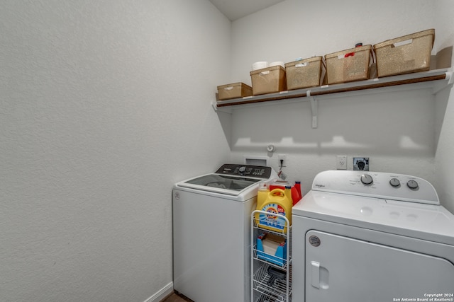 washroom with washing machine and clothes dryer