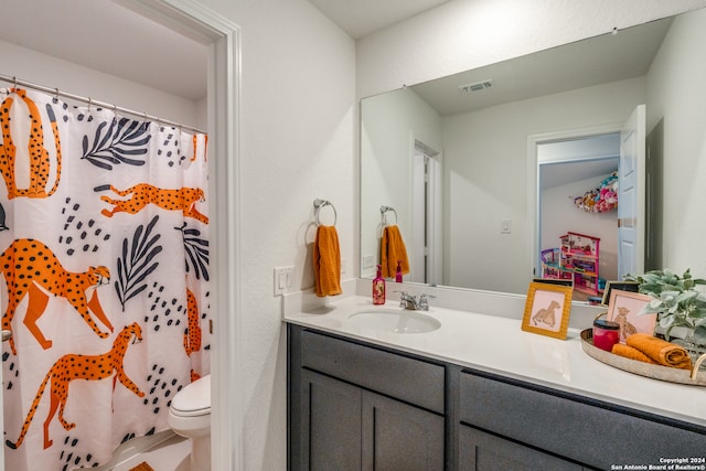 bathroom with vanity, toilet, and walk in shower