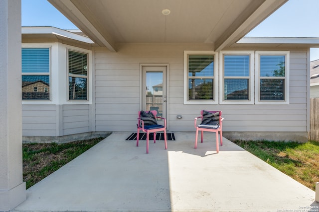 view of exterior entry featuring a patio