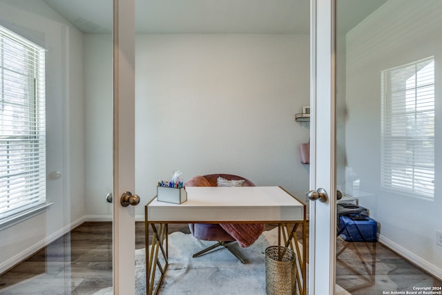 office area with french doors, wood-type flooring, and a healthy amount of sunlight