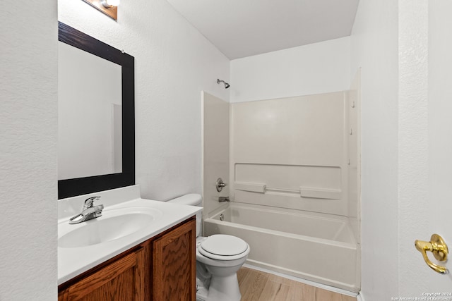 full bathroom with vanity, toilet, tub / shower combination, and hardwood / wood-style flooring