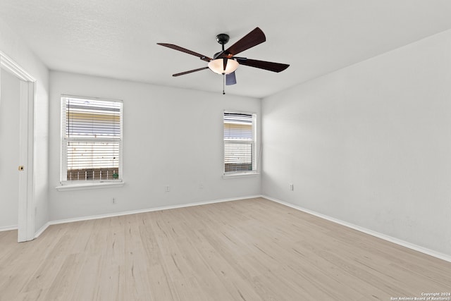 unfurnished room featuring ceiling fan and light hardwood / wood-style floors