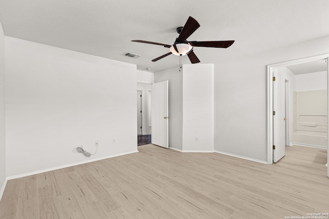 unfurnished bedroom with ceiling fan, ensuite bathroom, a textured ceiling, and light hardwood / wood-style flooring