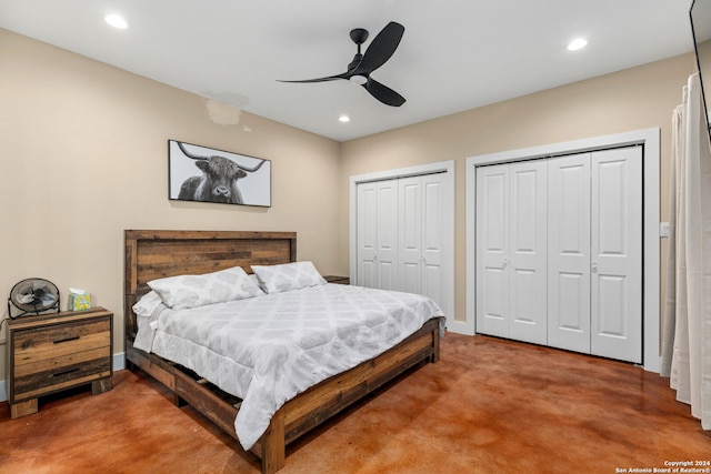 bedroom with ceiling fan, carpet, and multiple closets