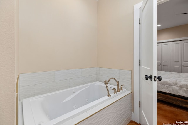 bathroom featuring tiled tub