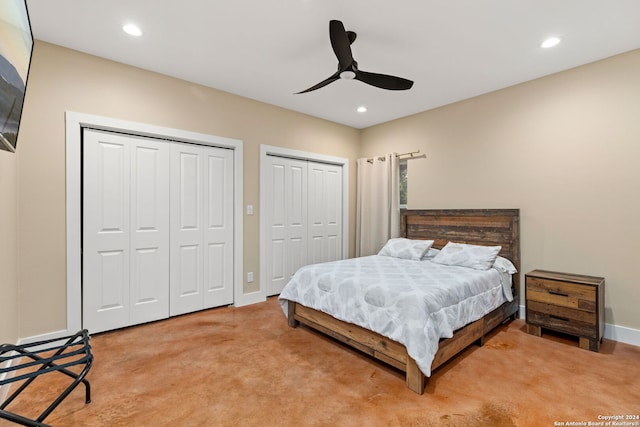 carpeted bedroom with multiple closets and ceiling fan