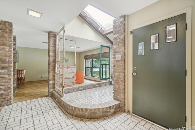 bathroom with brick wall and a skylight