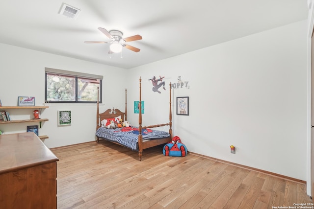 bedroom with ceiling fan and light hardwood / wood-style floors