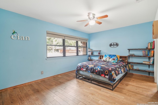 bedroom with ceiling fan and light hardwood / wood-style flooring