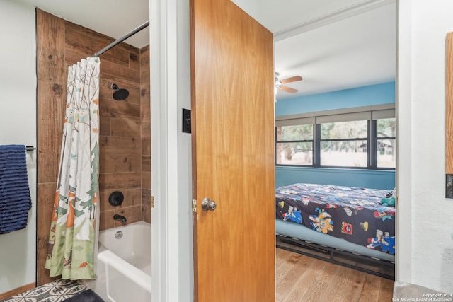 bathroom featuring hardwood / wood-style flooring, shower / tub combo with curtain, and ceiling fan