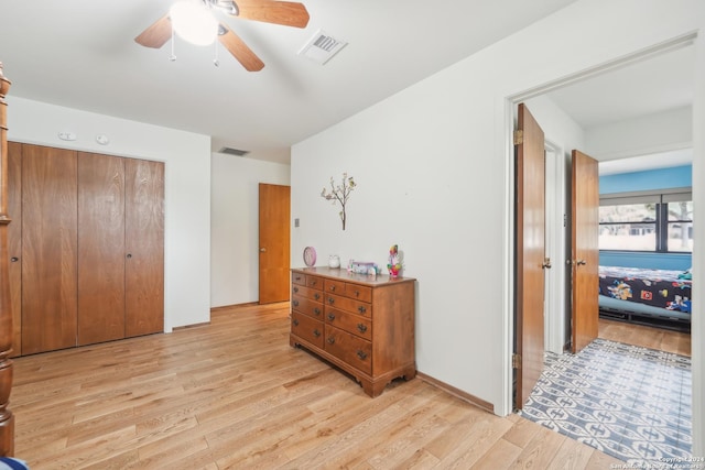 bedroom with a closet, ceiling fan, and light hardwood / wood-style flooring