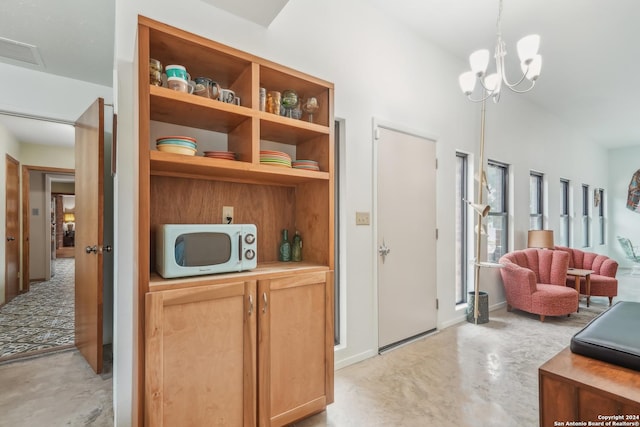 interior space featuring an inviting chandelier and decorative light fixtures