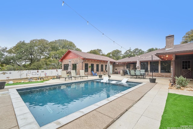 view of swimming pool with a patio area