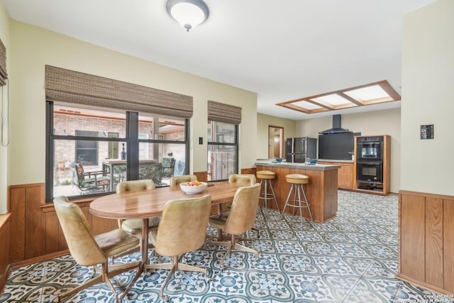 dining room with wooden walls