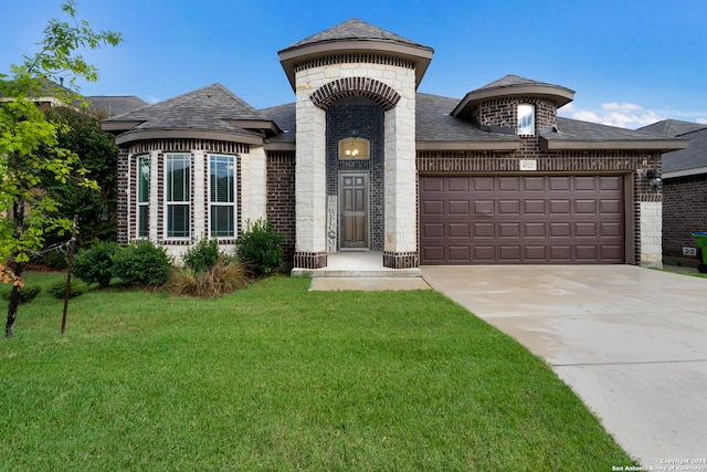 view of front of property featuring a garage and a front yard