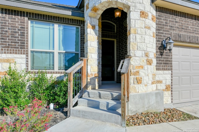 view of exterior entry with a garage