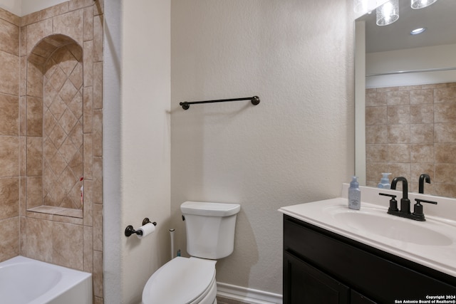 full bathroom with tiled shower / bath, vanity, and toilet