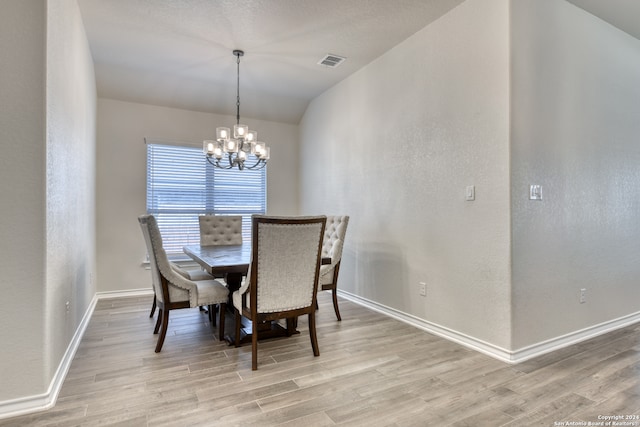 dining room featuring light hardwood / wood-style flooring and a chandelier