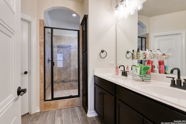 bathroom with vanity, hardwood / wood-style floors, and walk in shower