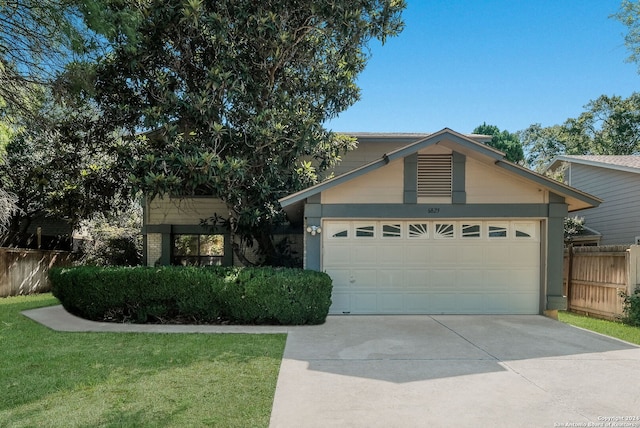 view of front of property with a front yard and a garage