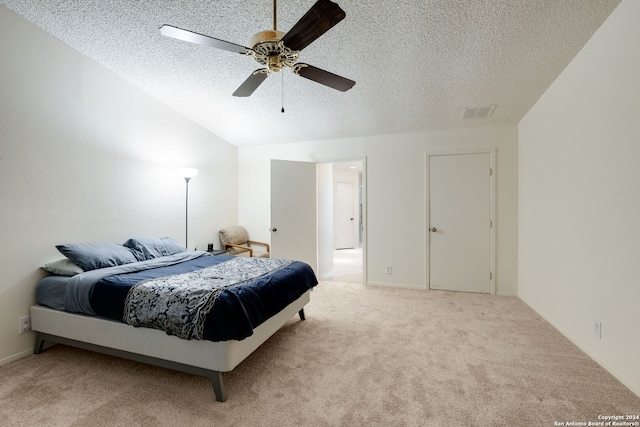 carpeted bedroom featuring a textured ceiling, ceiling fan, and lofted ceiling