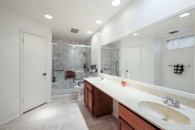 bathroom featuring a shower with door, tile patterned floors, toilet, vanity, and a textured ceiling