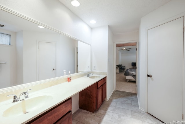 bathroom featuring tile patterned floors, ceiling fan, a textured ceiling, and vanity