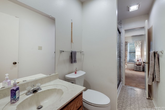 bathroom with vanity, toilet, and an enclosed shower