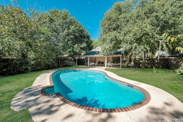 view of swimming pool with a lawn and a patio area