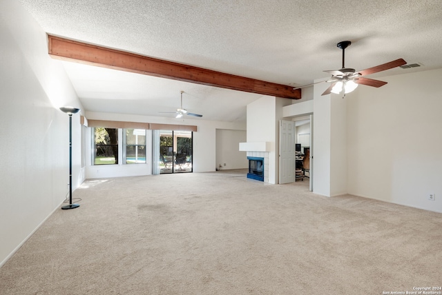 unfurnished living room featuring a fireplace, ceiling fan, beam ceiling, and light colored carpet