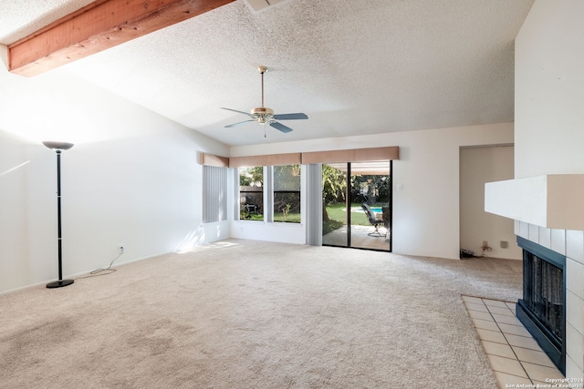 unfurnished living room featuring a fireplace, light carpet, a textured ceiling, ceiling fan, and vaulted ceiling with beams