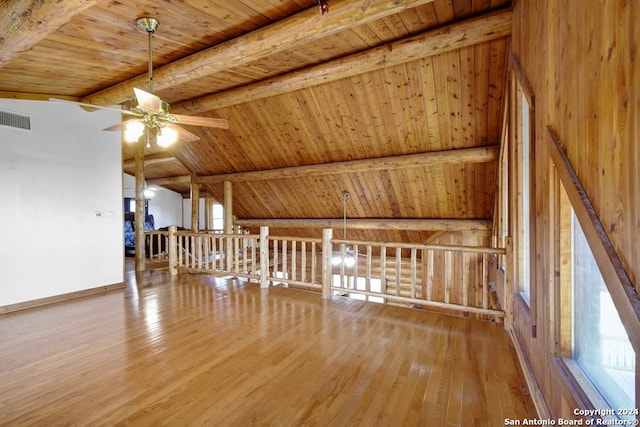 bonus room with ceiling fan, vaulted ceiling with beams, wooden ceiling, and hardwood / wood-style flooring